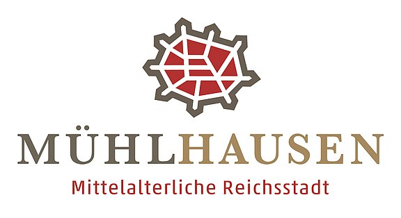 Grafik vom Umriss der historischen Altstadt mit Stadtmauer, Schriftzug: Mühlhausen - Mittelalterliche Reichstadt